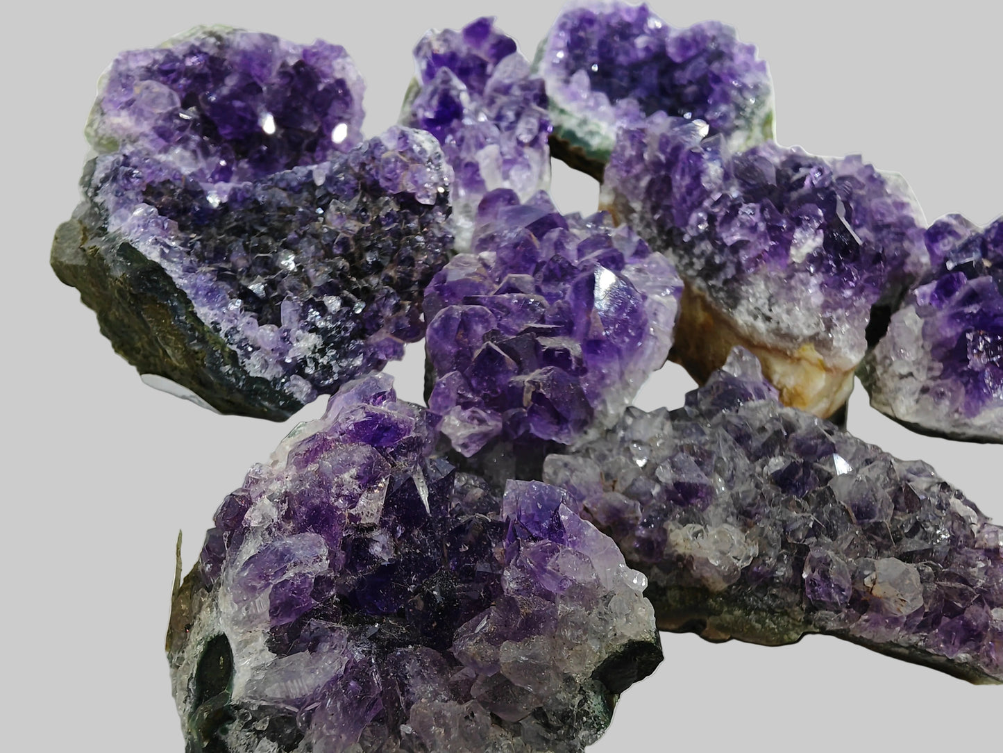 Amethyst crystal clusters on a white background_Earthstore UK