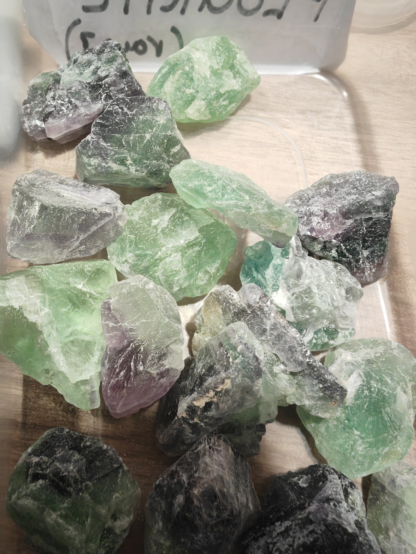 Collection of green and purple fluorite crystals.