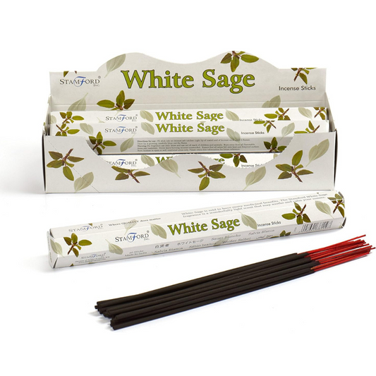 A box of Stamford White Sage incense sticks with several sticks visible in front, featuring green leaf designs on the packaging.
