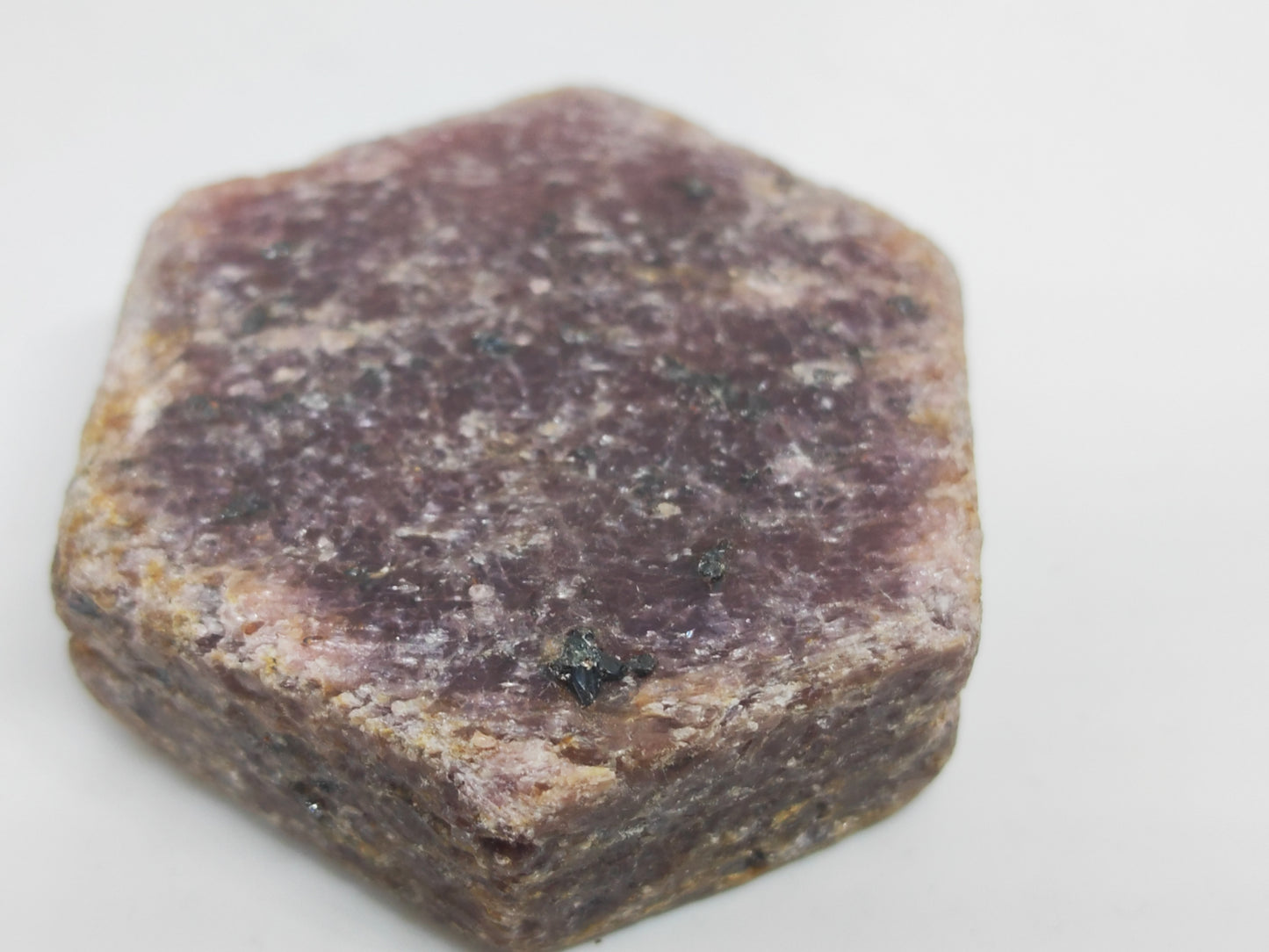 Hexagonal purple stone on a white background