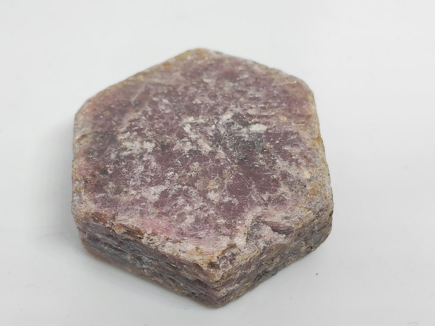 Hexagonal purple stone on a white background