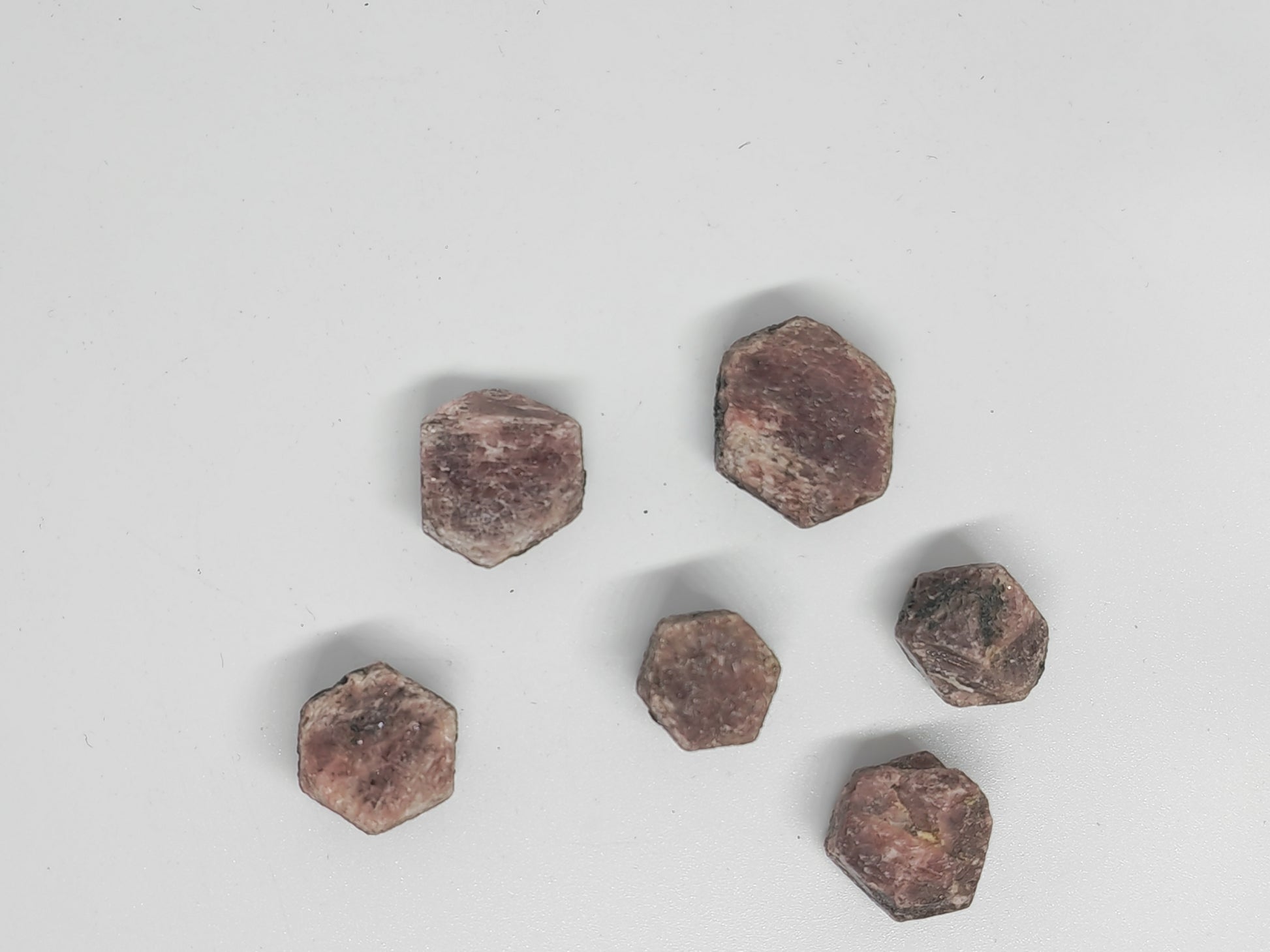 Hexagonal brown stones on a light gray background