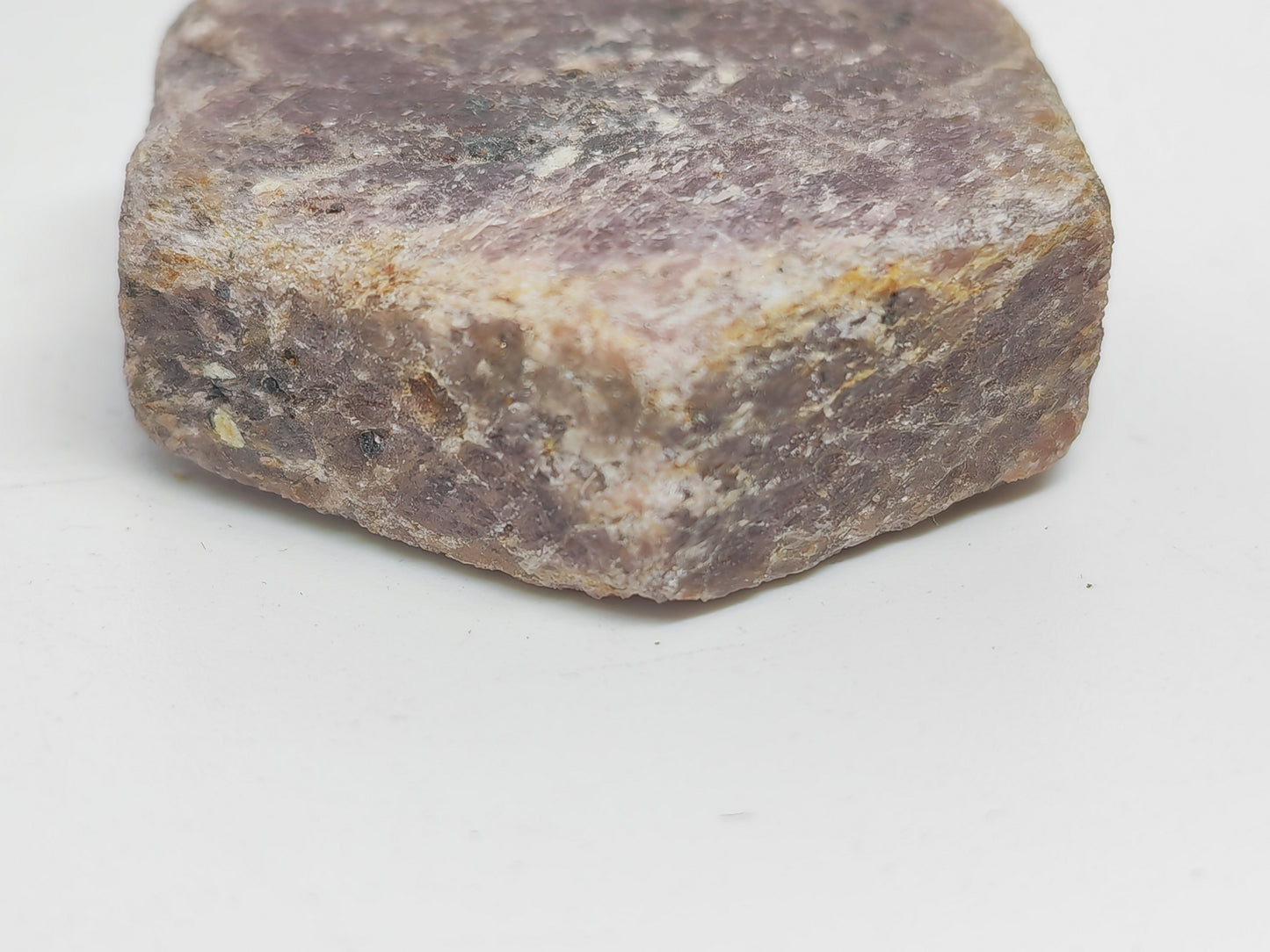 Close-up of a rough-textured stone on a white background