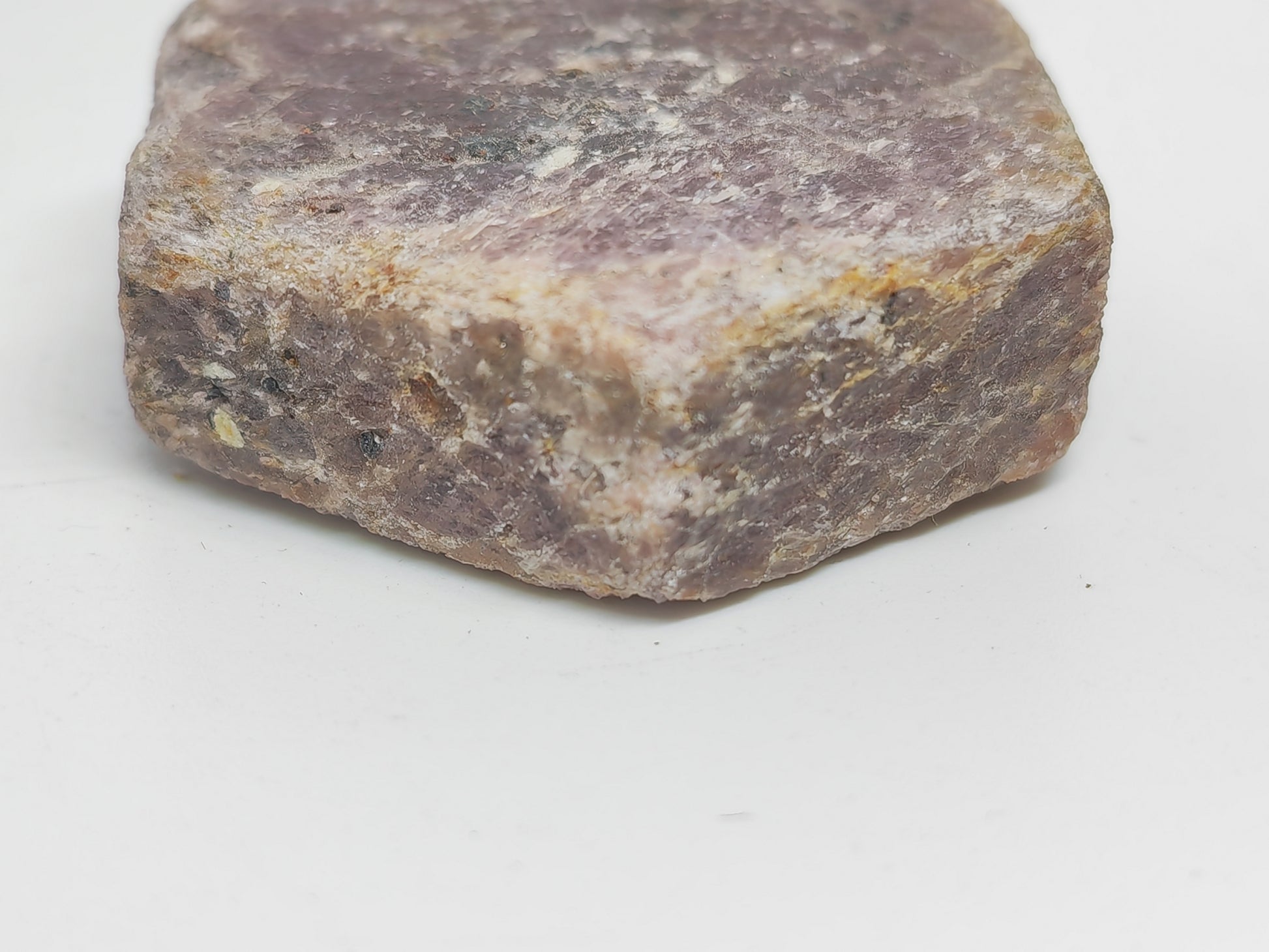 Close-up of a rough-textured stone on a white background