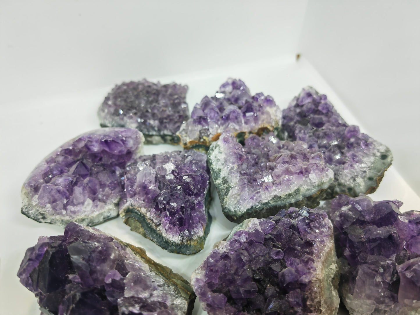 Amethyst crystal clusters on a white background