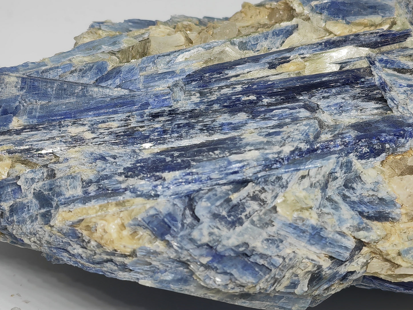 Close-up of a crystal rock with blue and beige colors on a gray background