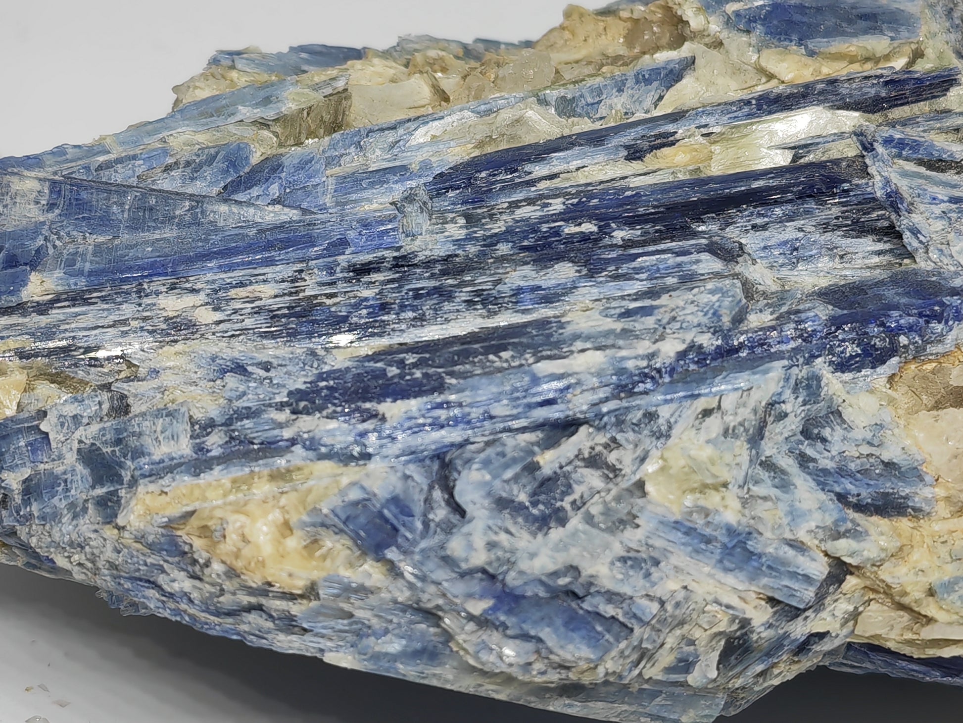 Close-up of a crystal rock with blue and beige colors on a gray background