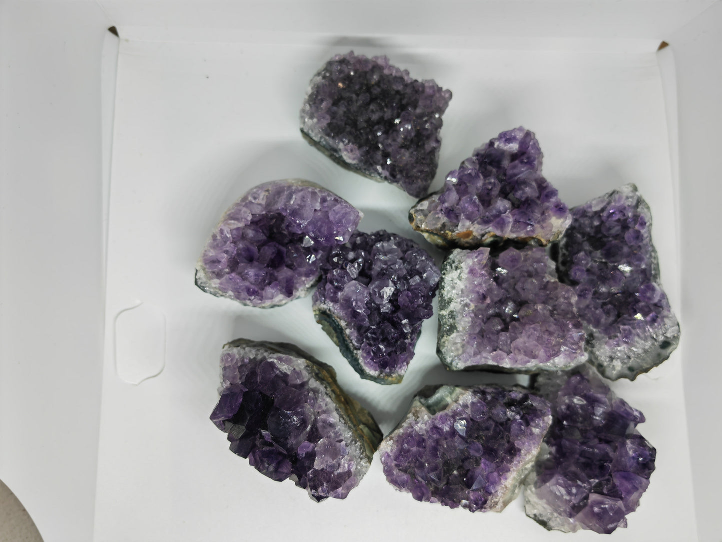 Amethyst crystal pieces on a white background