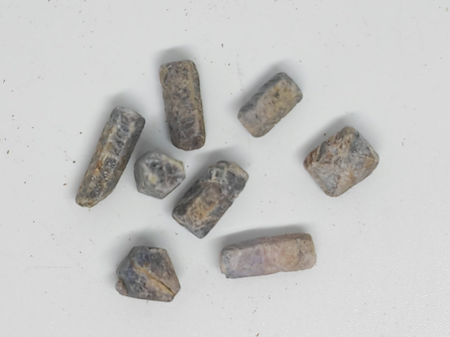 Small metallic objects on a white surface