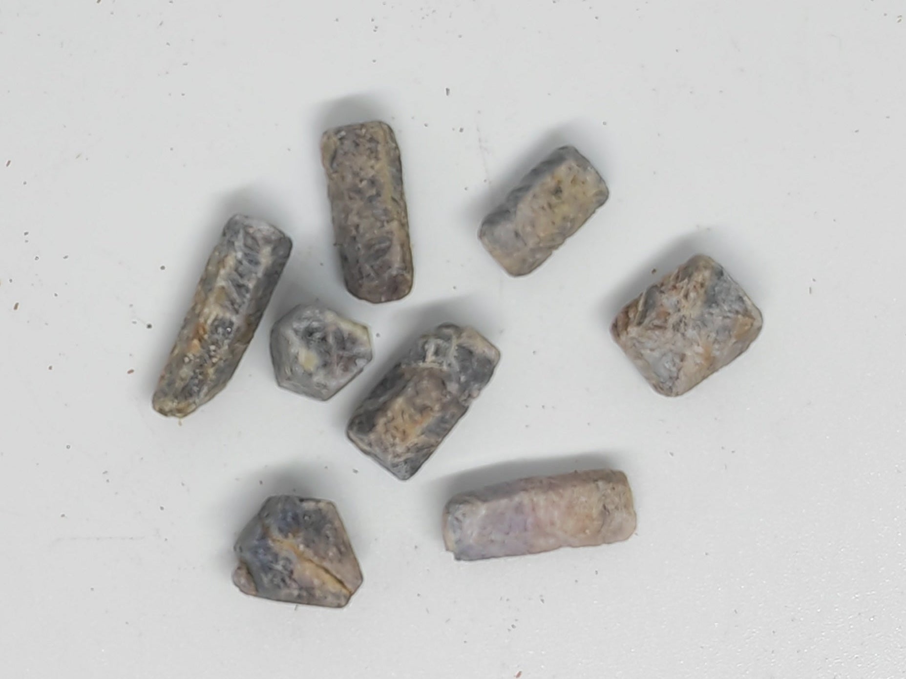 Small metallic objects on a white surface