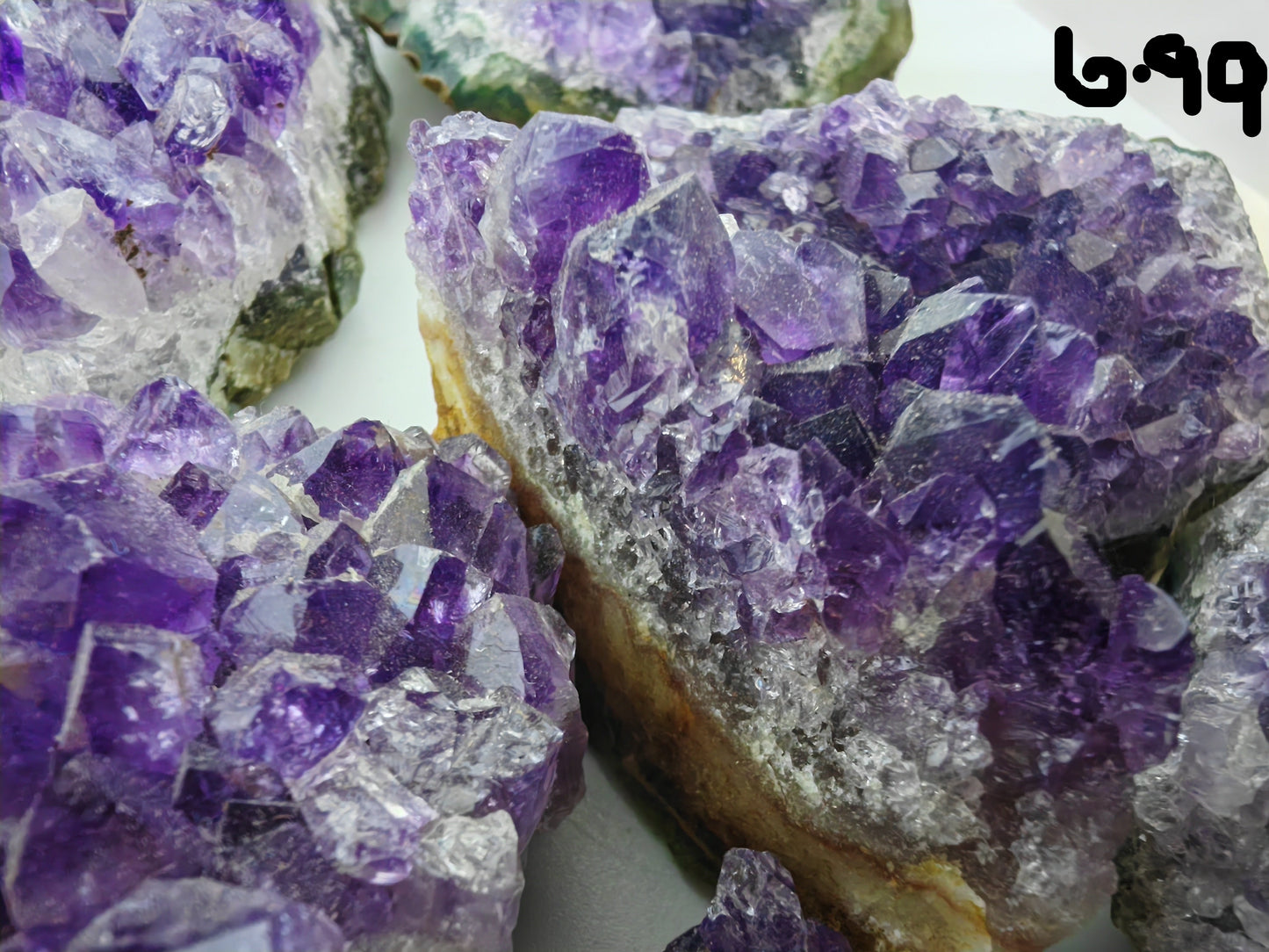 Close-up of purple crystal formations on a white background